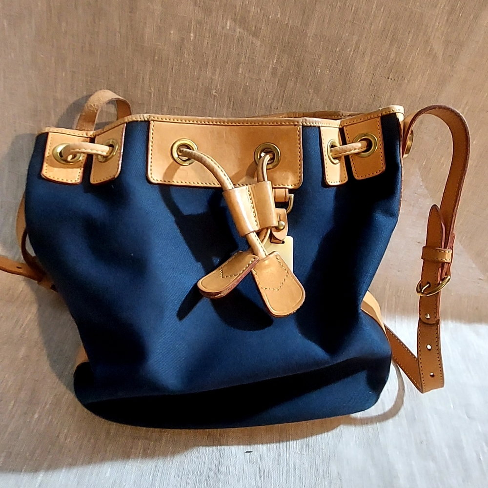 A navy blue fabric and leather  Dooney & Bourke bucket bag.